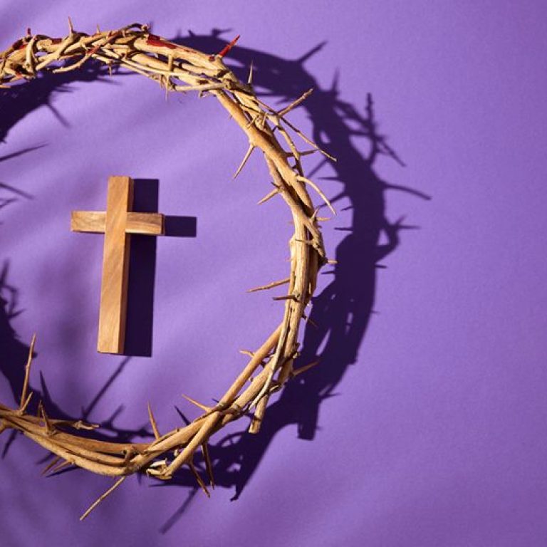 Lent season, Holy week and Good friday concept. Crown of torns and cross on purple background